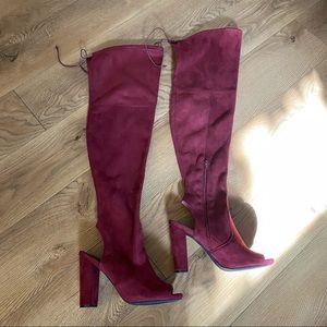 Burgundy over-the-knee suede boots.